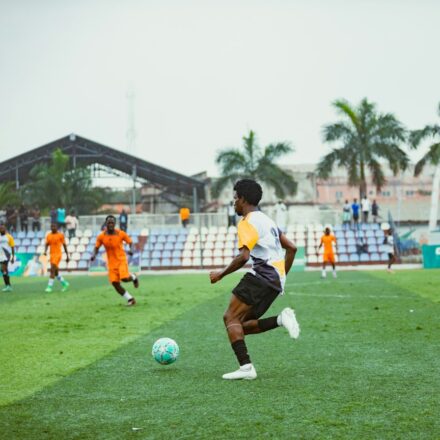Football player training on a pitch for an article about youth football development in Ghana